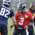 Seattle Seahawks quarterback Russell Wilson (3) greets tight end Luke Willson (82) at the start of NFL football practice on Wednesday, Jan. 15, 2014, in Renton, Wash. The Seahawks are to play the San Francisco 49ers on Sunday in the NFC championship. (AP Photo/Ted S. Warren)