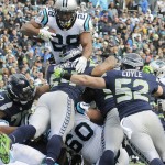 Carolina Panthers running back Jonathan Stewart (28) heads for the end zone for a touchdown against the Seattle Seahawks during the first half of an NFL divisional playoff football game, Sunday, Jan. 17, 2016, in Charlotte, N.C. (AP Photo/Mike McCarn)