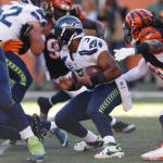 Seattle Seahawks quarterback Russell Wilson (3) is sacked by Cincinnati Bengals defensive end Wallace Gilberry, right, in overtime of an NFL football game, Sunday, Oct. 11, 2015, in Cincinnati. (AP Photo/Gary Landers)
