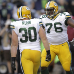 Green Bay Packers fullback John Kuhn (30) celebrates his touchdown against the Seattle Seahawks with Mike Daniels (76) in the first half of an NFL football game, Thursday, Sept. 4, 2014, in Seattle. (AP Photo/Stephen Brashear)