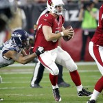 Arizona Cardinals quarterback Drew Stanton (5) is pressured by Seattle Seahawks defensive end Michael Bennett (72) during the second half of an NFL football game, Sunday, Jan. 3, 2016, in Glendale, Ariz. (AP Photo/Rick Scuteri)