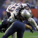 New England Patriots running back LeGarrette Blount (29), top, is tackled by Seattle Seahawks free safety Earl Thomas (29) during the first half of NFL Super Bowl XLIX football game Sunday, Feb. 1, 2015, in Glendale, Ariz. (AP Photo/Mark Humphrey)