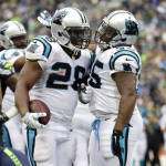 Carolina Panthers running back Jonathan Stewart, (28) is greeted by teammate Mike Tolbert, right, after scoring a touchdown against the Seattle Seahawks in the second half of an NFL football game, Sunday, Oct. 18, 2015, in Seattle. (AP Photo/Elaine Thompson)