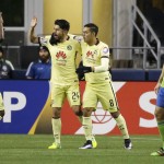 Club America forward Oribe Peralta, second from left, is greeted by teammates Darwin Quintero, left, and Andres Andrade as Seattle Sounders midfielder Andreas Ivanshitz walks past after Peralta scored a goal during the second half of a CONCACAF Champions League soccer quarterfinal, Tuesday, Feb. 23, 2016, in Seattle. The match ended in a 2-2 tie. (AP Photo/Ted S. Warren)
