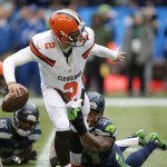 Seattle Seahawks' Bruce Irvin (51) grabs for Cleveland Browns quarterback Johnny Manziel in the first half of an NFL football game, Sunday, Dec. 20, 2015, in Seattle. (AP Photo/Scott Eklund)