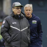 Seattle Seahawks head coach Pete Carroll, right, talks with Seahawks owner Paul Allen on the field during warmups before an NFL football game against the Carolina Panthers, Sunday, Oct. 18, 2015, in Seattle. (AP Photo/Elaine Thompson)