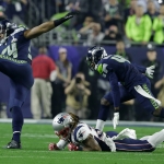 Seattle Seahawks middle linebacker Bobby Wagner (54) gets past New England Patriots running back Brandon Bolden (38) after intercepting a pass during the second half of NFL Super Bowl XLIX football game Sunday, Feb. 1, 2015, in Glendale, Ariz. (AP Photo/Michael Conroy)
