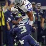 Seattle Seahawks' Russell Wilson (3) tackles Dallas Cowboys' Greg Hardy who intercepted  a pass from Wilson in the second half of an NFL football game Sunday, Nov. 1, 2015, in Arlington, Texas. (AP Photo/Brandon Wade)