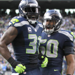 Seattle Seahawks' Kam Chancellor, left, and K.J. Wright, right, celebrate a play against the St. Louis Rams in the second half of an NFL football game, Sunday, Dec. 28, 2014, in Seattle. (AP Photo/John Froschauer)