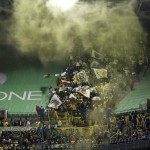 Club America supporters cheer as a yellow smoke effect is set off in the second half of a CONCACAF Champions League soccer quarterfinal against the Seattle Sounders, Tuesday, Feb. 23, 2016, in Seattle. The match ended in a 2-2 draw. (AP Photo/Ted S. Warren)