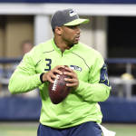 Seattle Seahawks' Russell Wilson prepares to throw a pass as he warms up before an NFL football game against the Dallas Cowboys Tuesday, Dec. 31, 2013, in Arlington, Texas. (AP Photo/Michael Ainsworth)