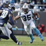 Carolina Panthers fullback Mike Tolbert (35) runs against Seattle Seahawks cornerback Jeremy Lane (20) during the first half of an NFL divisional playoff football game, Sunday, Jan. 17, 2016, in Charlotte, N.C. (AP Photo/Bob Leverone)