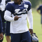 Seattle Seahawks running back Marshawn Lynch walks off the field Saturday, Aug. 2, 2014, after a session of NFL football training camp in Renton, Wash. Lynch watched from the sidelines and did not take part in drills. (AP Photo/Ted S. Warren)