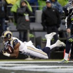 St. Louis Rams' Kenny Britt, left, dives into the end zone on a touchdown reception as Seattle Seahawks' Richard Sherman follows in the first half of an NFL football game, Sunday, Dec. 27, 2015, in Seattle. (AP Photo/John Froschauer)