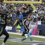 Carolina Panthers tight end Greg Olsen, right, catches a pass for a touchdown ahead of Seattle Seahawks cornerback Richard Sherman, left, in the second half of an NFL football game, Sunday, Oct. 18, 2015, in Seattle. (AP Photo/Elaine Thompson)