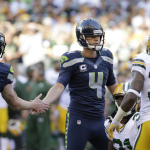 Seattle Seahawks kicker Steven Hauschka (4) slaps hands with holder Jon Ryan in front of Green Bay Packers' Sam Shields (37) after Hauschka kicked a field goal in the first half of an NFL football game, Thursday, Sept. 4, 2014, in Seattle. (AP Photo/Elaine Thompson)