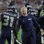 Seattle Seahawks head coach Pete Carroll celebrates with strong safety Kam Chancellor (31) after an interception during the second half of NFL Super Bowl XLIX football game against the New England Patriots Sunday, Feb. 1, 2015, in Glendale, Ariz. (AP Photo/David J. Phillip)