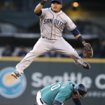 San Diego Padres shortstop Everth Cabrera leaps out of the way as Seattle Mariners' Logan Morrison slides into second base after being forced out in the third inning in a baseball game Monday, June 16, 2014, in Seattle. Cabrera completed the double play on Mike Zunino at first. (AP Photo/Elaine Thompson)