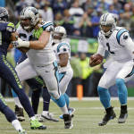Carolina Panthers quarterback Cam Newton, right, scrambles with the football as teammate Tyronne Green (68) blocks in the first half of an NFL football game against the Seattle Seahawks, Sunday, Oct. 18, 2015, in Seattle. (AP Photo/Elaine Thompson)