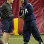 Seattle Seahawks' Marshawn Lynch (24) talks with a coach during a team practice for NFL Super Bowl XLIX football game, Friday, Jan. 30, 2015, in Tempe, Ariz. The Seahawks play the New England Patriots in Super Bowl XLIX on Sunday, Feb. 1, 2015. (AP Photo/Matt York)