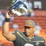 Seattle Seahawks quarterback Russell Wilson, of Team Irvin, acknowledges the fans after being name offensive player of the game after the NFL Pro Bowl football game Sunday, Jan. 31, 2016, in Honolulu. Team Irvin won 49-27. (AP Photo/Eugene Tanner)