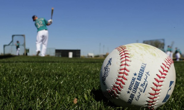 Seattle Mariners catcher Steve Clevenger warms up to bat during spring training baseball practice S...