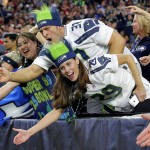 Seattle Seahawks fans cheer during the first half of an NFL football game against the Arizona Cardinals, Sunday, Jan. 3, 2016, in Glendale, Ariz. (AP Photo/Ross D. Franklin)