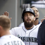 Seattle Mariners' Dustin Ackley is congratulated after scoring against the Oakland Athletics during the second inning of a baseball game Saturday, May 9, 2015, in Seattle. (AP Photo/Elaine Thompson)