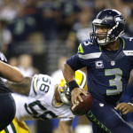 Seattle Seahawks quarterback Russell Wilson looks to pass in the second half of an NFL football game against the Green Bay Packers, Thursday, Sept. 4, 2014, in Seattle. The Seahawks defeated the Packers 36-16. (AP Photo/Scott Eklund)