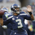 Seattle Seahawks quarterback Russell Wilson winds up to pass against the Green Bay Packers in the first half of an NFL football game, Thursday, Sept. 4, 2014, in Seattle. (AP Photo/Stephen Brashear)