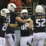 Washington tight end Drew Sample, second from right, is greeted by teammates after he caught a pass for a touchdown against Utah during the first half of an NCAA college football game, Saturday, Nov. 7, 2015, in Seattle. (AP Photo/Ted S. Warren)