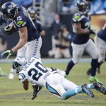 Carolina Panthers free safety Kurt Coleman (20) tackles Seattle Seahawks wide receiver Jermaine Kearse (15) during the second half of an NFL divisional playoff football game, Sunday, Jan. 17, 2016, in Charlotte, N.C. (AP Photo/Chuck Burton)
