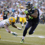 Seattle Seahawks wide receiver Ricardo Lockette avoids Green Bay Packers free safety Ha Ha Clinton-Dix, left, to score a touchdown in the first half of an NFL football game, Thursday, Sept. 4, 2014, in Seattle. (AP Photo/Elaine Thompson)