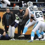 Carolina Panthers middle linebacker Luke Kuechly (59) intercepts a Seattle Seahawks quarterback Russell Wilson thrown ball during the first half of an NFL divisional playoff football game, Sunday, Jan. 17, 2016, in Charlotte, N.C. Kuechly scored a touchdown on the play. (AP Photo/Mike McCarn)