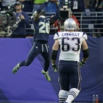 Seattle Seahawks cornerback Jeremy Lane (20) intercepts a pass by New England Patriots quarterback Tom Brady as guard Dan Connolly (63) watches during the first half of NFL Super Bowl XLIX football game Sunday, Feb. 1, 2015, in Glendale, Ariz. (AP Photo/Kathy Willens)