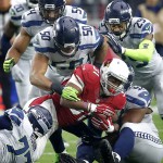 Arizona Cardinals running back David Johnson (31) is stopped by Seattle Seahawks outside linebacker K.J. Wright (50), free safety Earl Thomas (29), defensive tackle Ahtyba Rubin (77), defensive tackle Brandon Mebane (92) and  middle linebacker Bobby Wagner (54) during the first half of an NFL football game, Sunday, Jan. 3, 2016, in Glendale, Ariz. (AP Photo/Rick Scuteri)