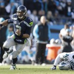 Seattle Seahawks quarterback Russell Wilson (3) runs by Carolina Panthers defensive tackle Kawann Short (99) during the first half of an NFL divisional playoff football game, Sunday, Jan. 17, 2016, in Charlotte, N.C. (AP Photo/Bob Leverone)