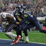 New England Patriots wide receiver Brandon LaFell (19) scores a touchdown against Seattle Seahawks free safety Earl Thomas and cornerback Tharold Simon, right, during the first half of NFL Super Bowl XLIX football game against the Seattle Seahawks Sunday, Feb. 1, 2015, in Glendale, Ariz. (AP Photo/Matt Slocum)