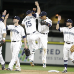 Seattle Mariners share congratulations after the team beat the Oakland Athletics in a baseball game Saturday, May 9, 2015, in Seattle. The Mariners won 7-2. (AP Photo/Elaine Thompson)