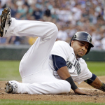 Seattle Mariners' Nelson Cruz scores against the Oakland Athletics in the first inning of a baseball game Saturday, May 9, 2015, in Seattle. (AP Photo/Elaine Thompson)