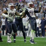New England Patriots defensive end Chandler Jones (95) celebrates after sacking Seattle Seahawks quarterback Russell Wilson with defensive tackle Sealver Siliga (96) during the first half of NFL Super Bowl XLIX football game Sunday, Feb. 1, 2015, in Glendale, Ariz. (AP Photo/Matt Rourke)