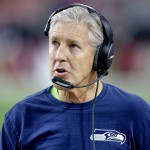 Seattle Seahawks head coach Pete Carroll makes a call during the first half of an NFL football game against the Arizona Cardinals, Sunday, Jan. 3, 2016, in Glendale, Ariz. (AP Photo/Ross D. Franklin)