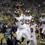 St. Louis Rams' Todd Gurley (30) spikes the ball after scoring a touchdown on a run against the Seattle Seahawks in the second half of an NFL football game, Sunday, Dec. 27, 2015, in Seattle. (AP Photo/Stephen Brashear)