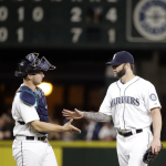 Seattle Mariners closing pitcher Joe Beimel, right, shares congratulations with catcher Mike Zunino after the team beat the Oakland Athletics in a baseball game Saturday, May 9, 2015, in Seattle. The Mariners won 7-2. (AP Photo/Elaine Thompson)