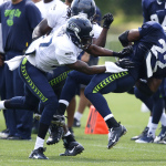 Seattle Seahawks running back Robert Turbin, right, is tackled by cornerback Tharold Simon, left, during practice drills, Saturday, Aug. 2, 2014, at NFL football training camp in Renton, Wash. (AP Photo/Ted S. Warren)
