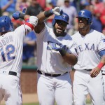 Texas Rangers designated hitter Prince Fielder, second from left, is congratulated by Rougned Odor (12) after hitting a three-run home run during the sixth inning of a baseball game against the Seattle Mariners, Wednesday, April 6, 2016, in Arlington, Texas. (AP Photo/Brandon Wade)