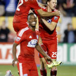 FC Dallas players Ryan Hollingshead, top left, Walker Zimmerman (25) and Fabian Castillo, foreground, celebrate a 4-2 victory against the Seattle Sounders FC on penalty kicks during the shootout period of an MLS soccer western conference semifinal playoff match Sunday, Nov. 8, 2015, in Frisco, Texas. (AP Photo/Brad Loper)