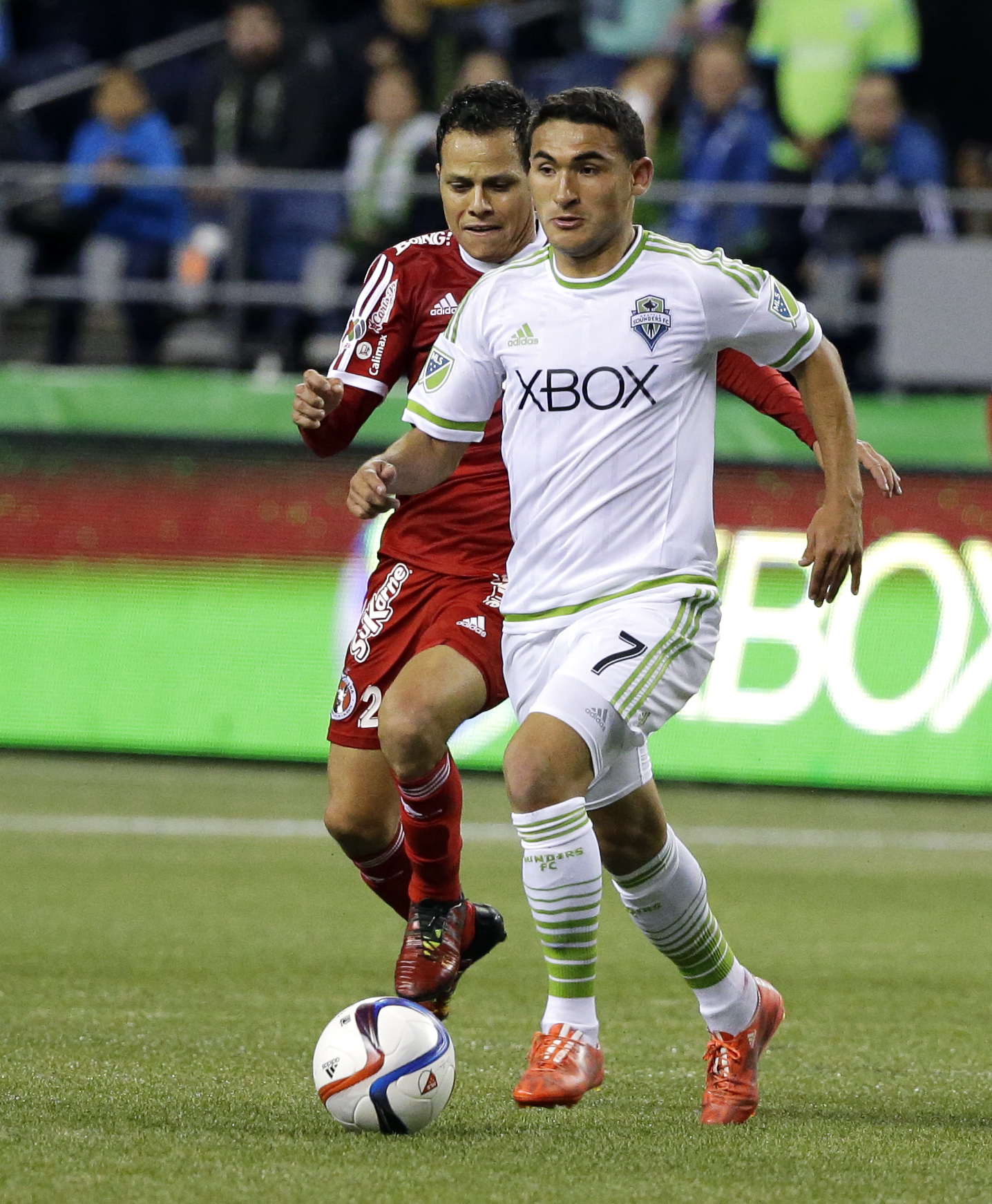 Seattle Sounders' Cristian Roldan, right, dribbles the ball away from Club Tijuana's Juan Carlos Nunez during the second half of an international friendly soccer match, Tuesday, March 24, 2015, in Seattle. The match ended in a 2-2 tie. (AP Photo/Ted S. Warren)