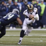 St. Louis Rams quarterback Case Keenum (17) scrambles as Seattle Seahawks' Bobby Wagner gives chase in the first half of an NFL football game, Sunday, Dec. 27, 2015, in Seattle. (AP Photo/Stephen Brashear)