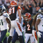 Cincinnati Bengals kicker Mike Nugent (2) celebrates after booting the winning field goal in overtime of an NFL football game against the Seattle Seahawks, Sunday, Oct. 11, 2015, in Cincinnati. The Bengals won 27-24. (AP Photo/Gary Landers)